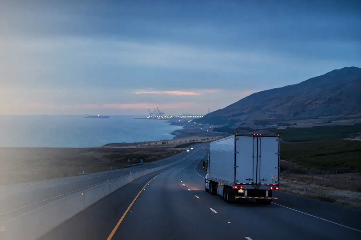 Freight traveling from California toward a working port and ocean vessel