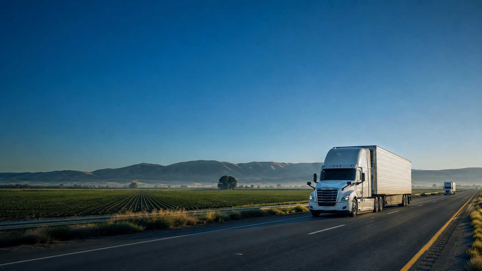 A refrigerated tractor-trailer traveling through California agricultural country